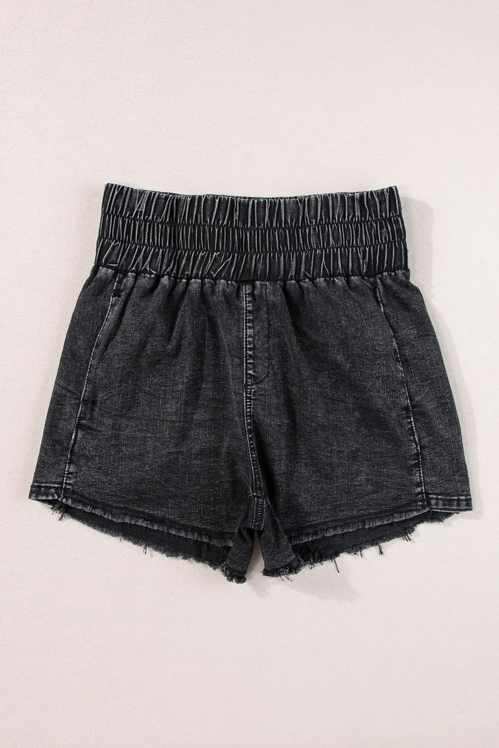 Black washed denim shorts with elastic smocked waist and frayed hem