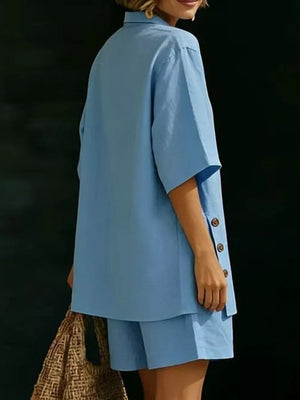 Blue linen shorts with button detail on the side of a matching relaxed top.