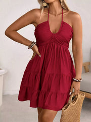 Red halter neck ruffled mini dress with tiered skirt and ruched bodice.