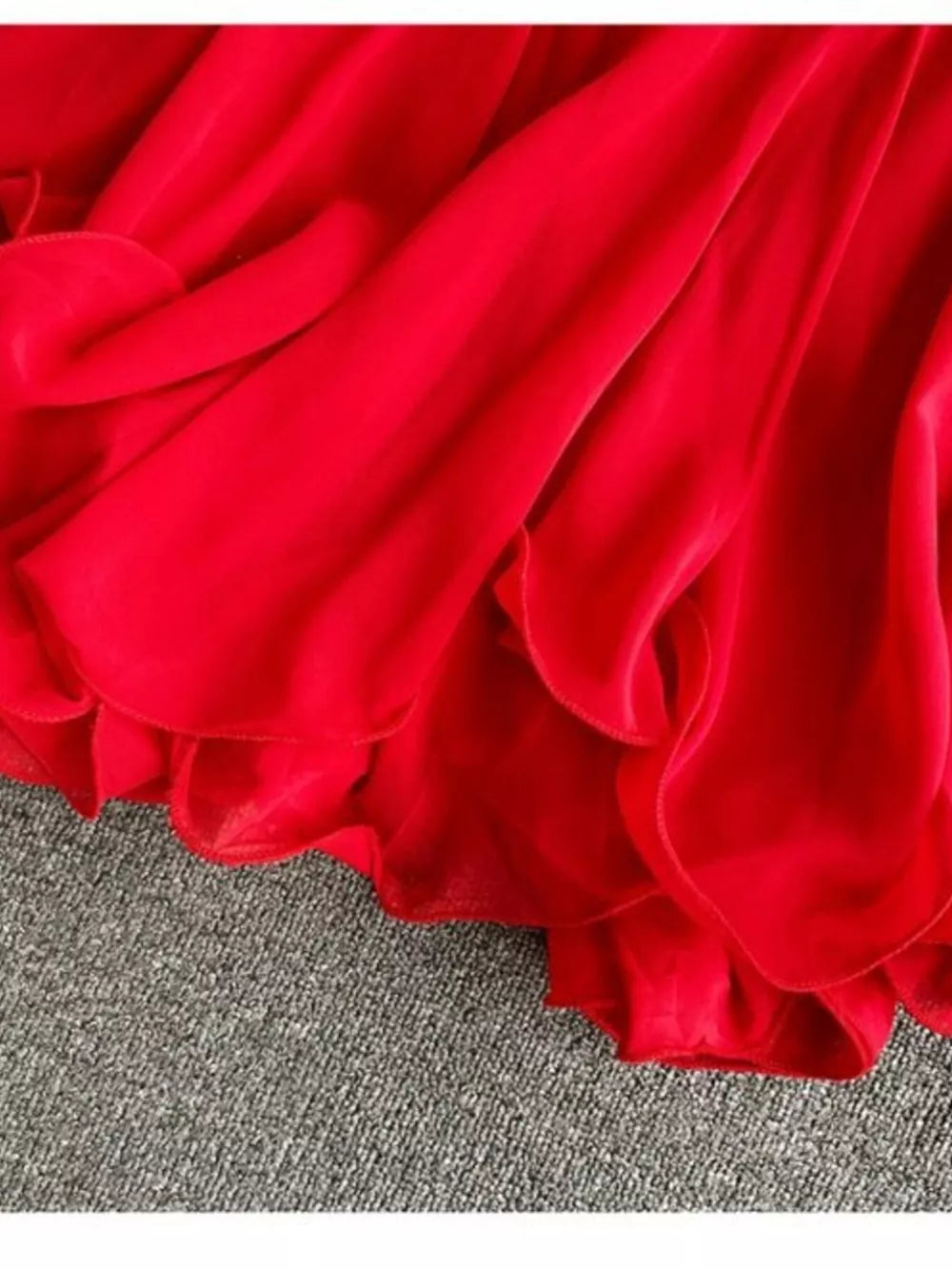 Red ruffled camisole with delicate spaghetti straps and layered chiffon detail.