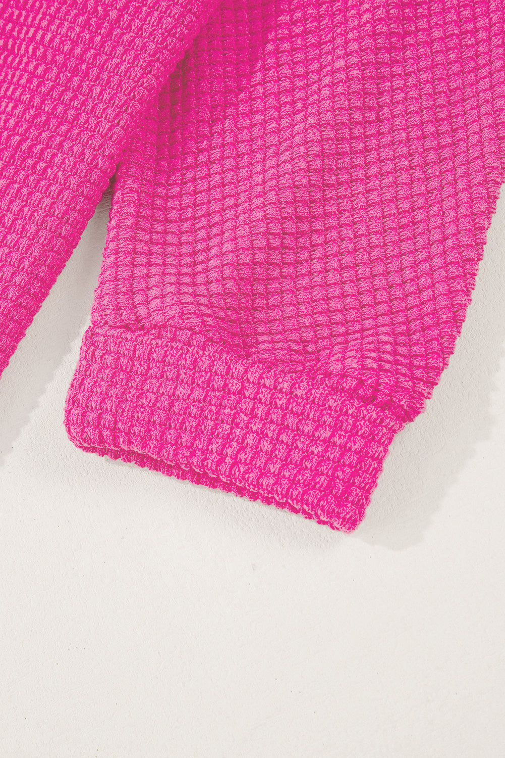 Hot Pink waffle knit sweater with ribbed cuffs and hem detail.