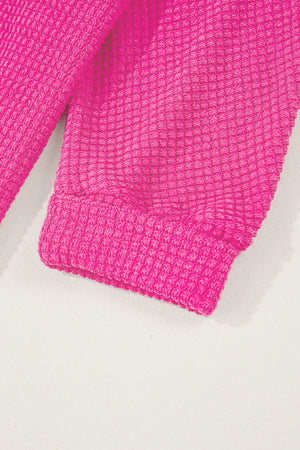 Hot Pink waffle knit sweater with ribbed cuffs and hem detail.