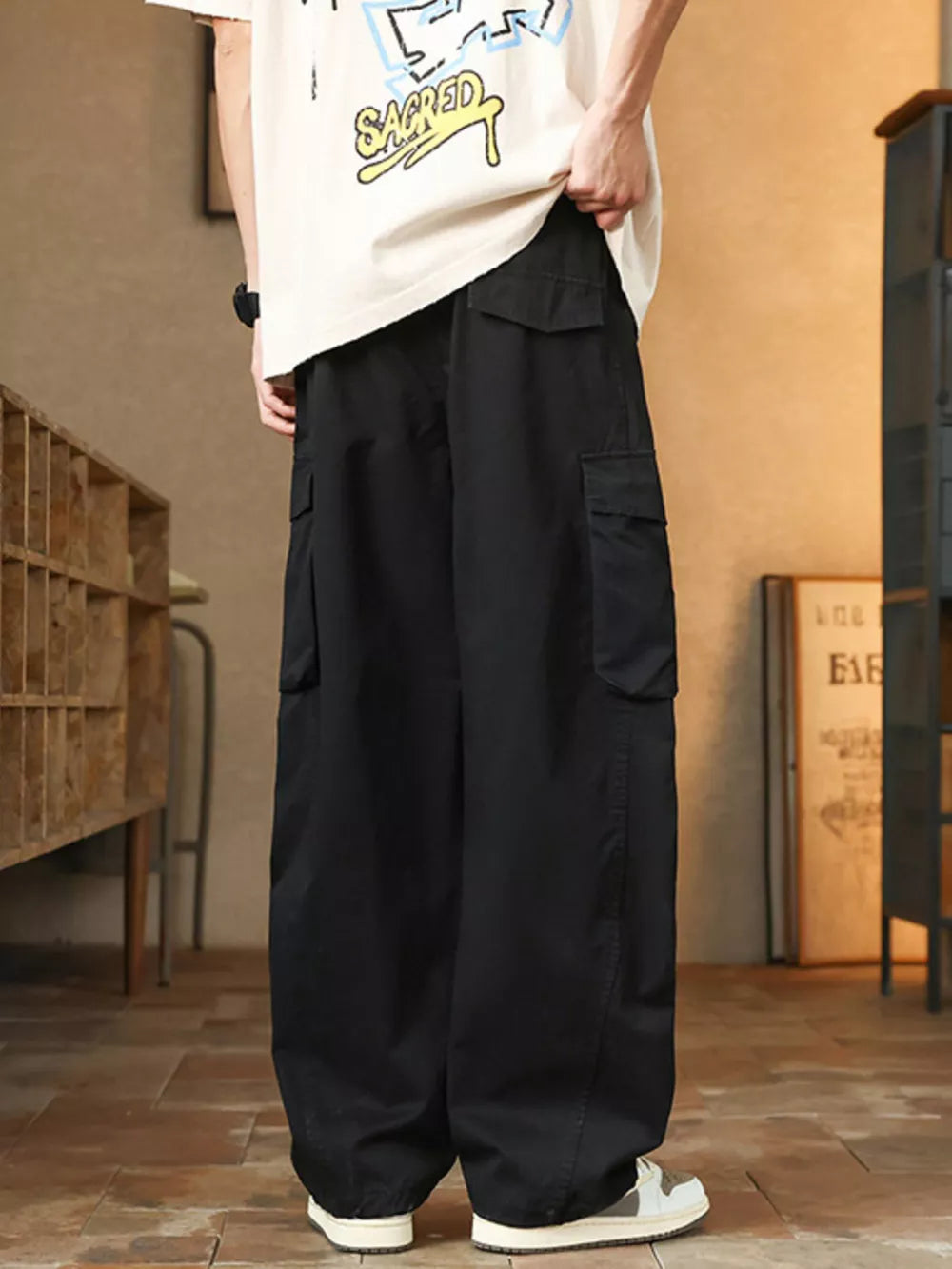 Men's black cargo pants with multiple pockets and a relaxed fit.