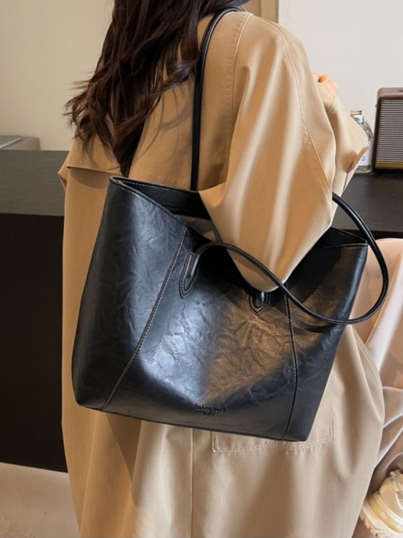 Black crinkled PU leather tote bag with top handles and a slouchy silhouette.