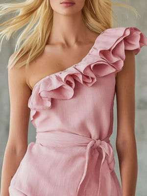 Blush pink one-shoulder wrap dress with dramatic ruffle trim and tie waist.
