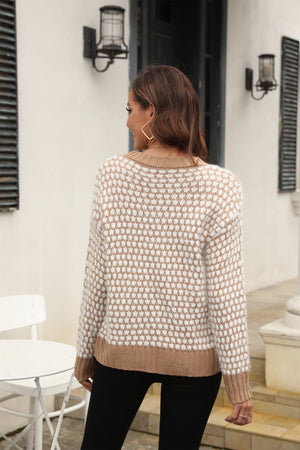 Textured bouclé knit sweater in camel and white geometric pattern with contrast trim.