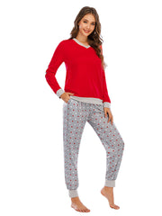Red long sleeve lounge top with grey trim and grey polka dot pants.