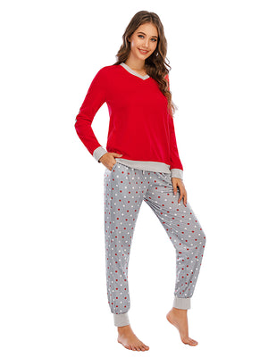 Red long sleeve lounge top with grey trim and grey polka dot pants.