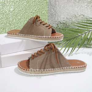 Khaki canvas lace-up open-toe flats with espadrille sole and brown laces.