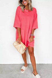 Coral cotton blend t-shirt mini dress with crew neck, drop shoulders, and pockets.