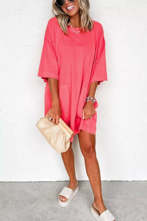 Coral cotton blend t-shirt mini dress with crew neck, drop shoulders, and pockets.