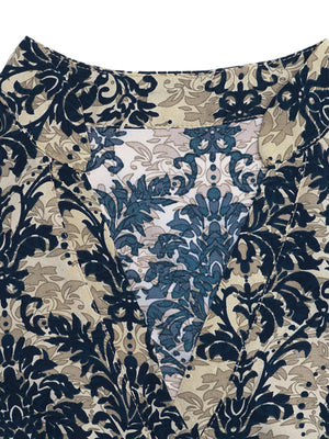 Maternity blouse with notch neckline and ornate floral print in navy, tan, and blue.