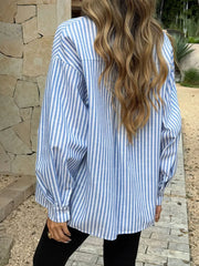 Relaxed fit blue and white striped cotton shirt with V-neck and button-down front.