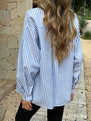 Relaxed fit blue and white striped cotton shirt with V-neck and button-down front.