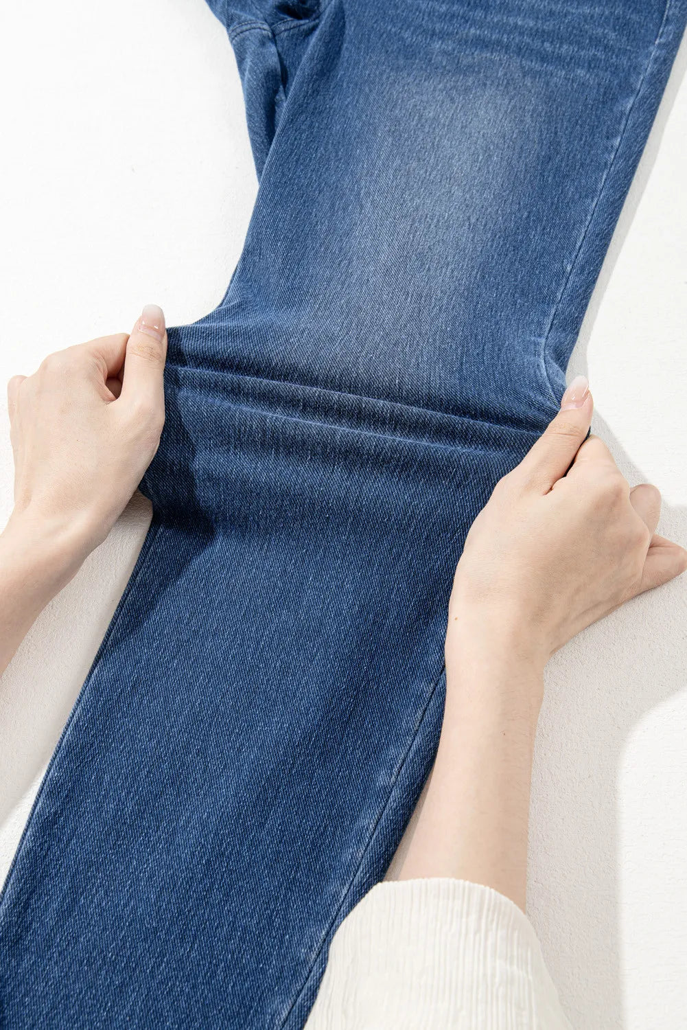 Denim-effect leggings in medium blue, showing stretch fabric and high-rise cut.