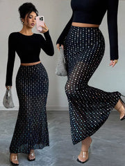Black sheer polka dot maxi skirt with a mermaid hem.