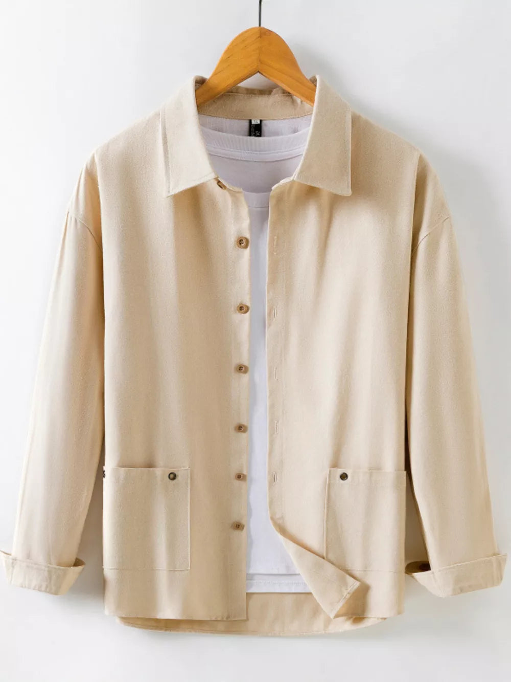 Khaki long sleeve button-up shirt with two chest pockets and a white t-shirt underneath.