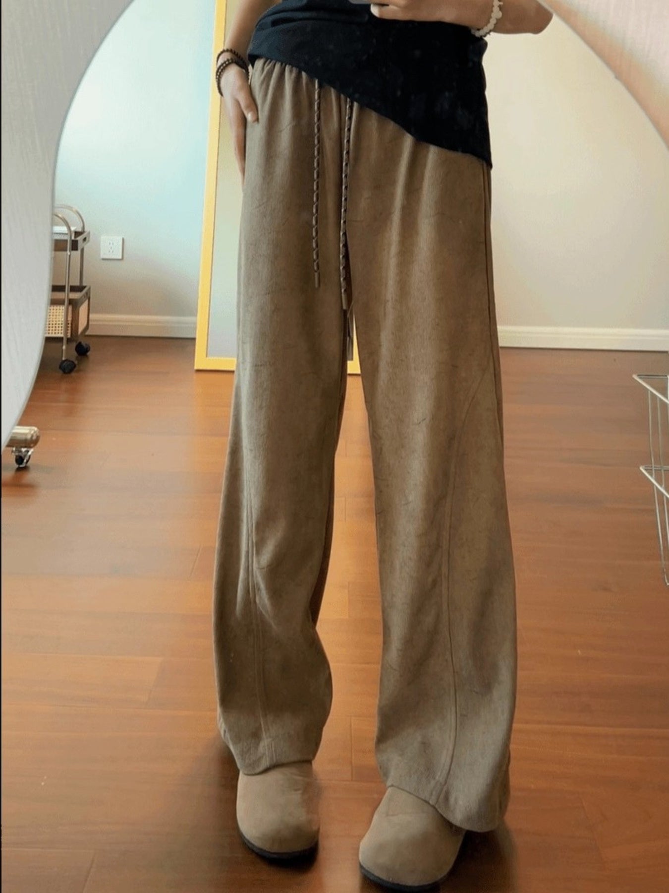 Men's beige corduroy drawstring pants with a relaxed fit.