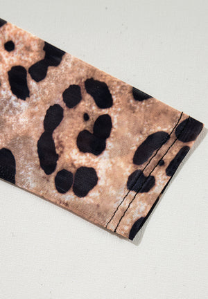 Sheer leopard print second-skin top with visible stitching detail.