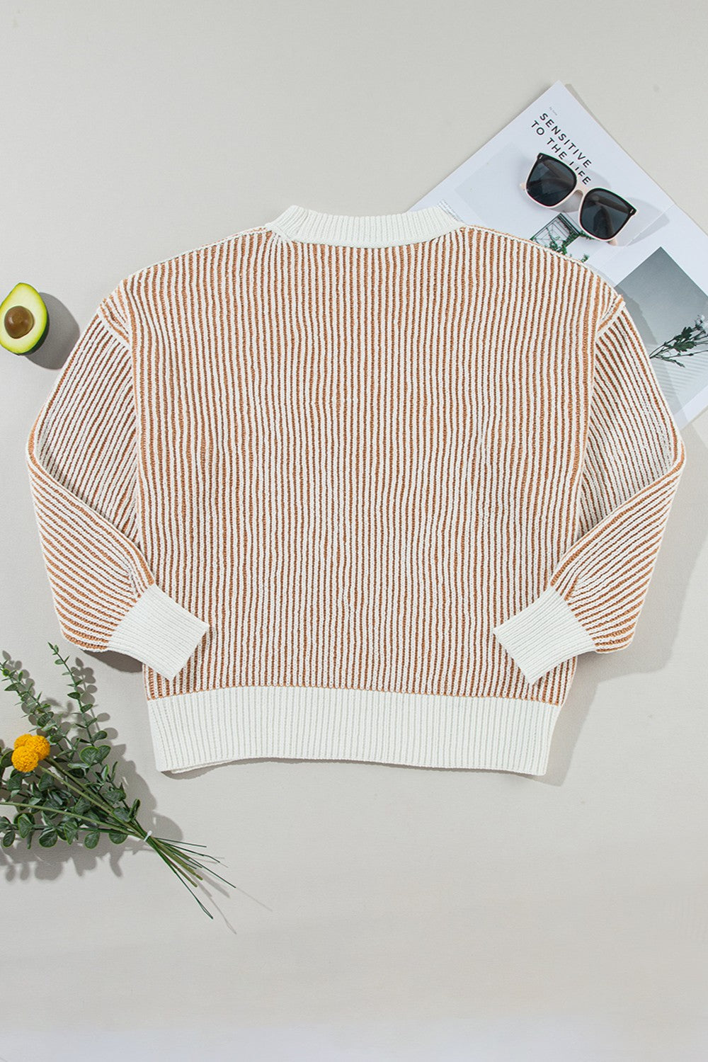 Vertical stripe drop-shoulder knit sweater in camel and white with ribbed cuffs and hem.
