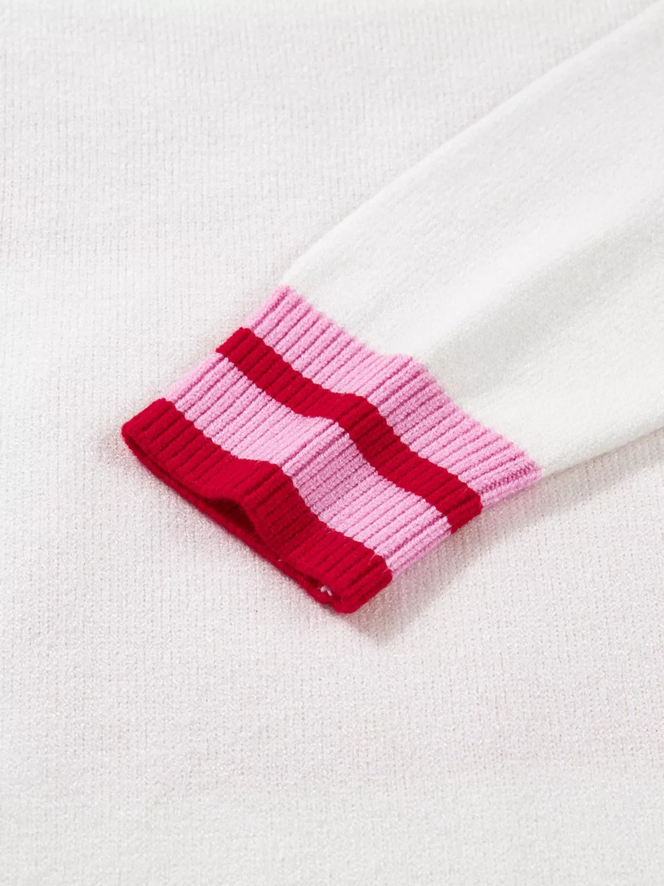 White sweater with striped cuffs in pink and red