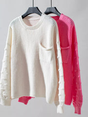 Chic pocketed knit sweater in ivory and hot pink with textured sleeves.