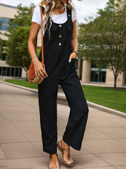Black button-front wide-leg jumpsuit with pockets, styled with a white tee and brown sandals.