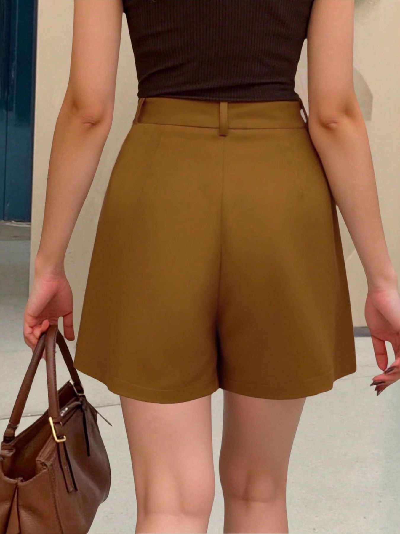 Brown pleated high-waisted shorts with belt loops and pockets.
