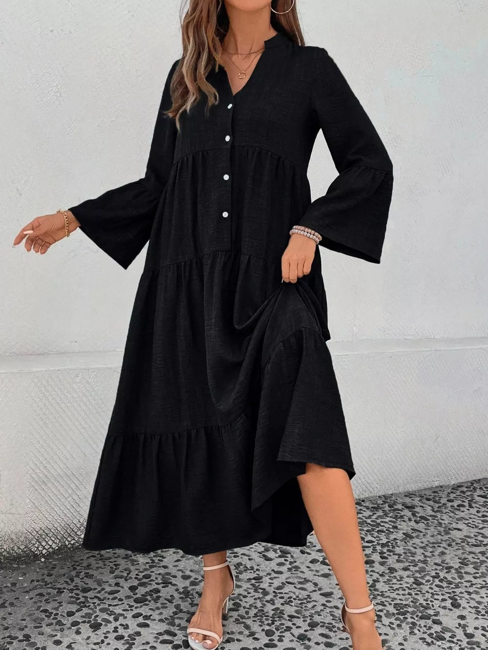 Black tiered ruffle hem V-neck dress with button front and bell sleeves.