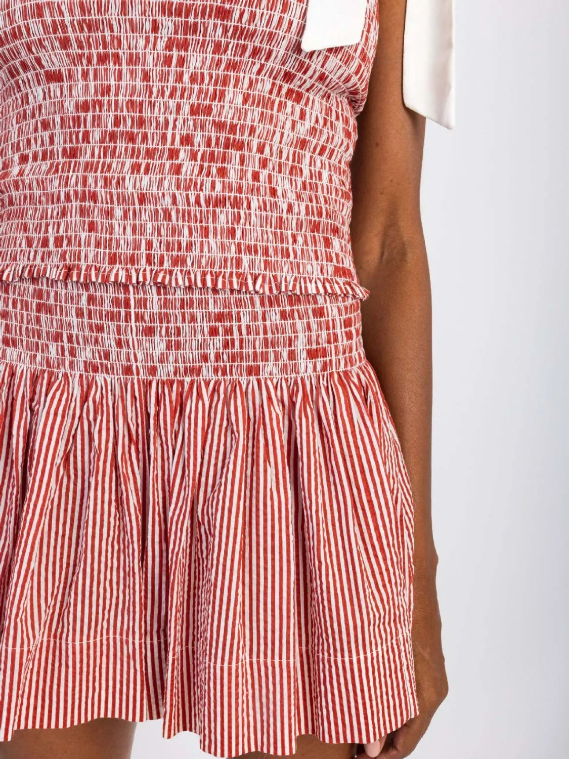 Smocked bodice and skirt set in red and white stripe and gingham patterns with tie straps.