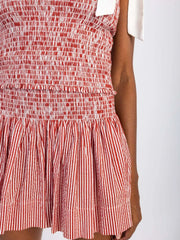 Smocked bodice and skirt set in red and white stripe and gingham patterns with tie straps.