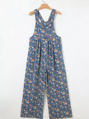 Floral denim overalls with adjustable straps and wide legs.