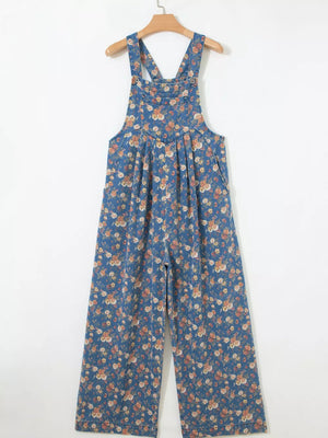 Floral denim overalls with adjustable straps and wide legs.