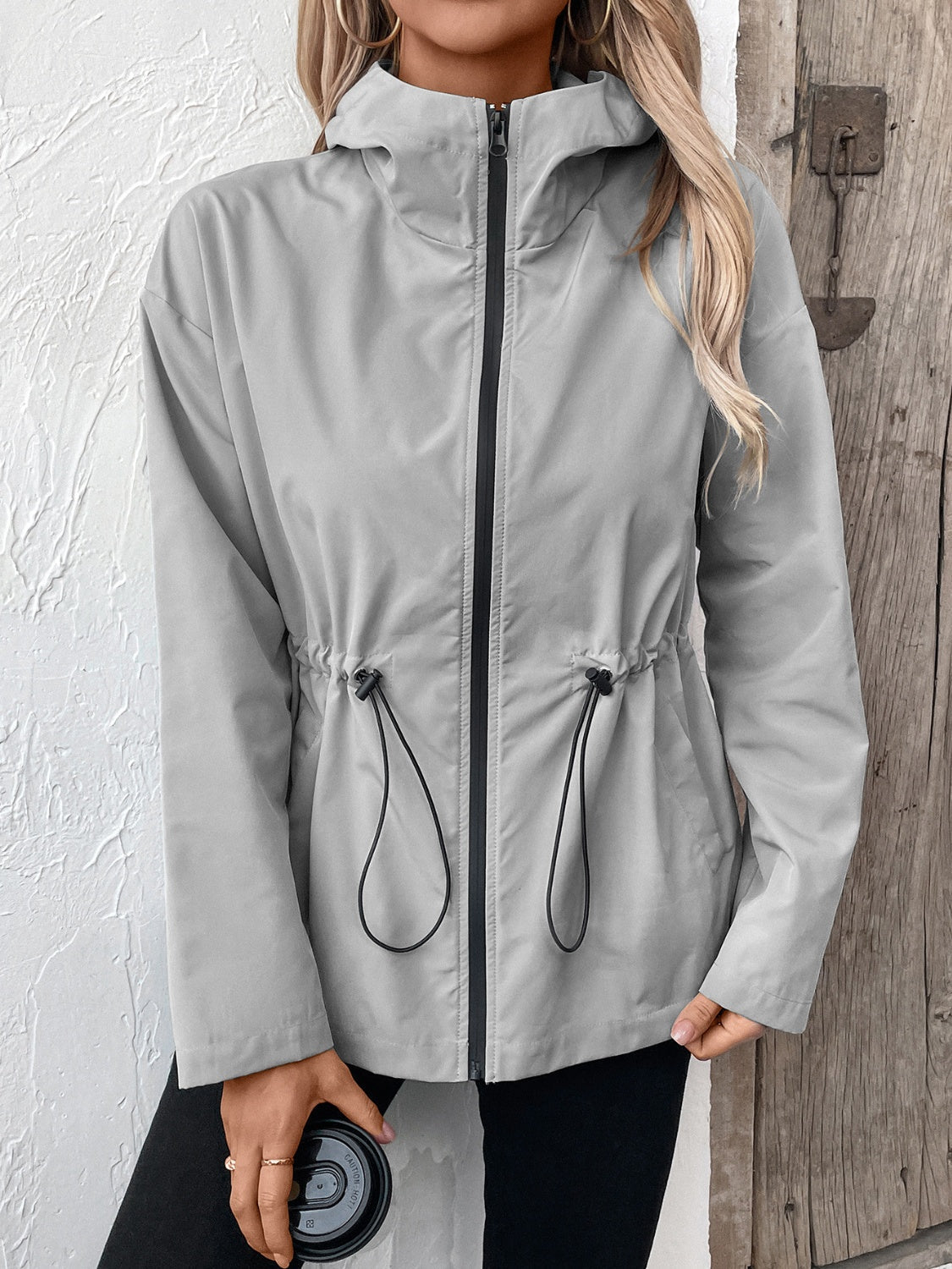 Gray hooded utility jacket with cinched waistline and black zipper