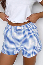 Light blue gingham boxer shorts with high-rise elastic waist and button fly.