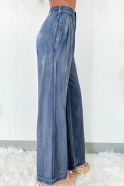 Pleated waist palazzo denim trousers in medium wash, wide leg, casual style.