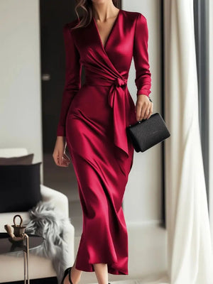 Burgundy satin wrap dress with tie waist and V-neck, long sleeves.