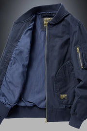 Navy bomber jacket with patch detail and zippered sleeve pocket.