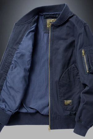 Navy bomber jacket with patch detail and zippered sleeve pocket.