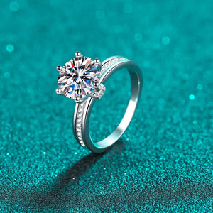Sterling silver ring with a large moissanite solitaire and pavé band.