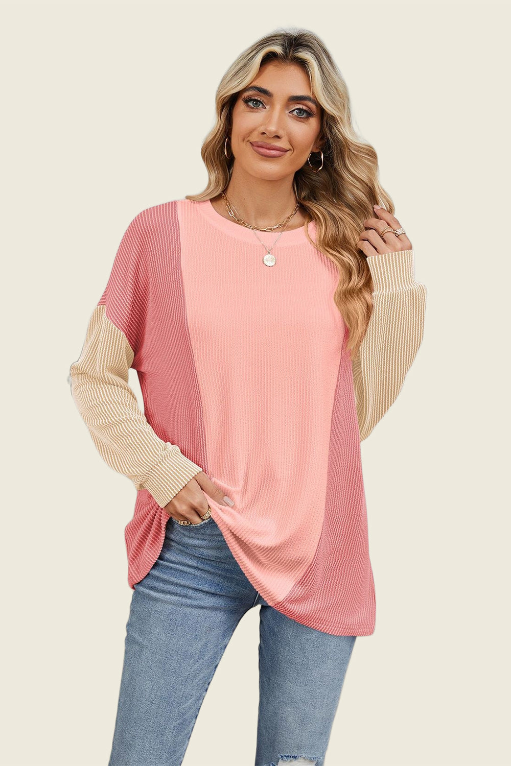 Colorblock waffle knit pullover sweater with crew neck and long sleeves in pink and tan.
