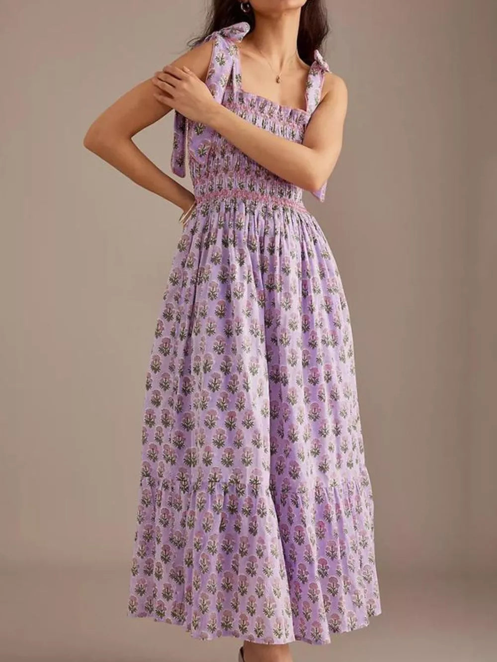 Lilac floral midi dress with smocked bodice and tie shoulders.