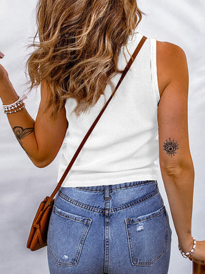 White ribbed scoop neck tank top with a textured knit, paired with blue denim jeans.