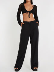 Black crochet tie-front bolero shrug with long sleeves and open knit detail.