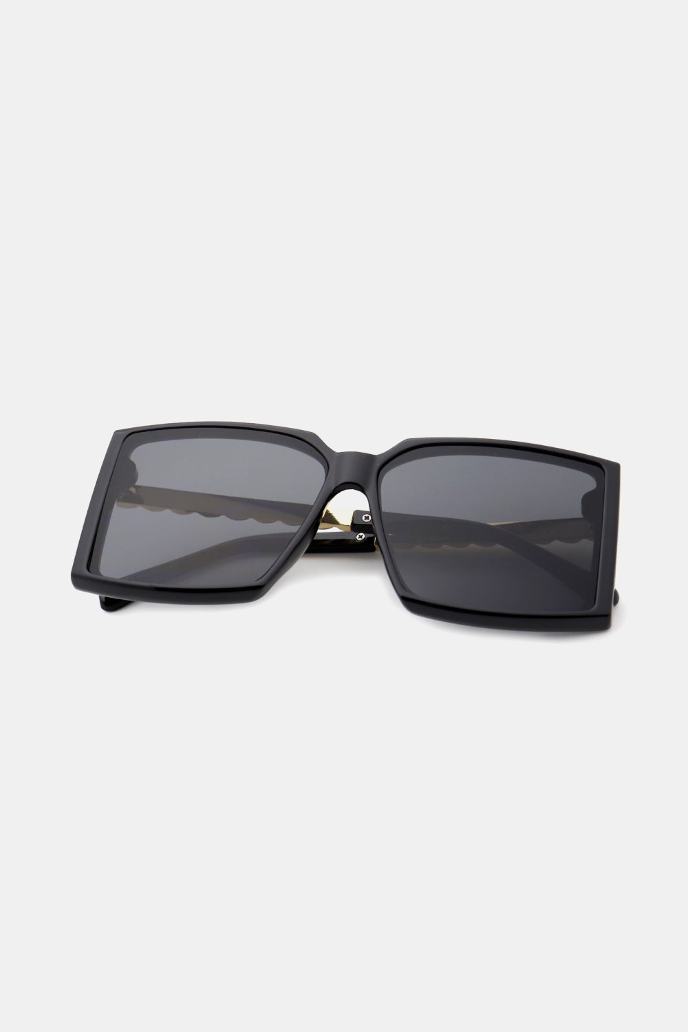 Black geometric sunglasses with gradient lenses and a bold square frame.