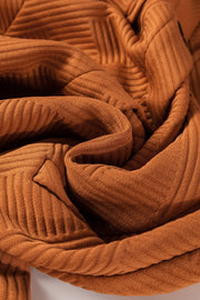 Caramel quilted overshirt jacket with textured ribbing and patch pocket detail.