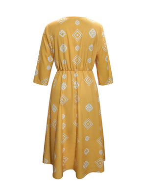 Yellow geometric print empire waist midi dress with 3/4 sleeves.