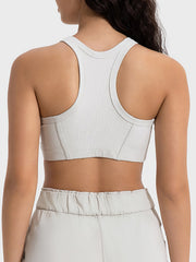 Ribbed racerback crop top in light grey with contour stitching detail.