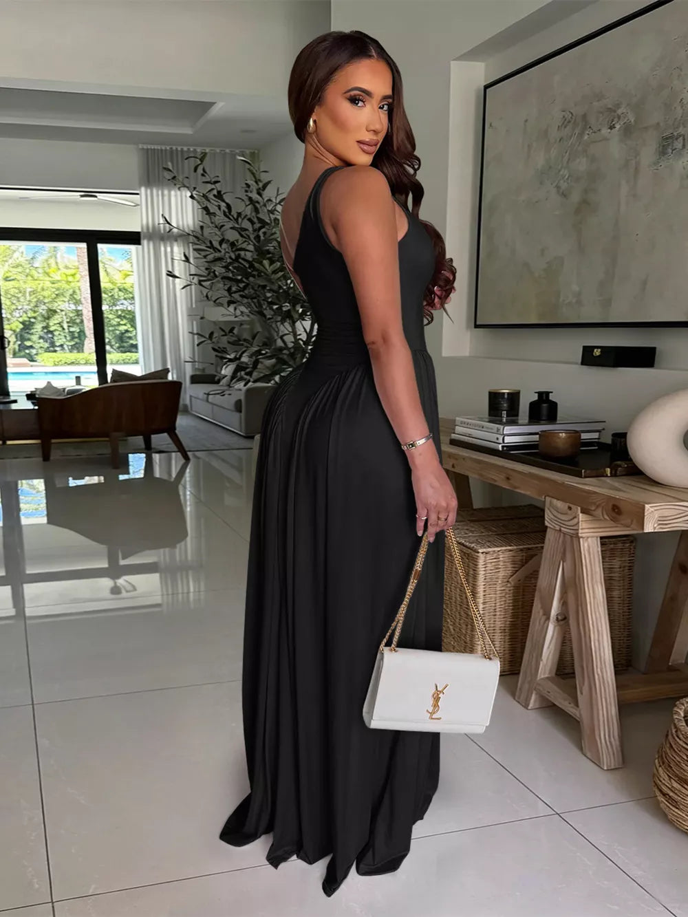 Black ruched one-shoulder maxi dress with gathered waist detail.