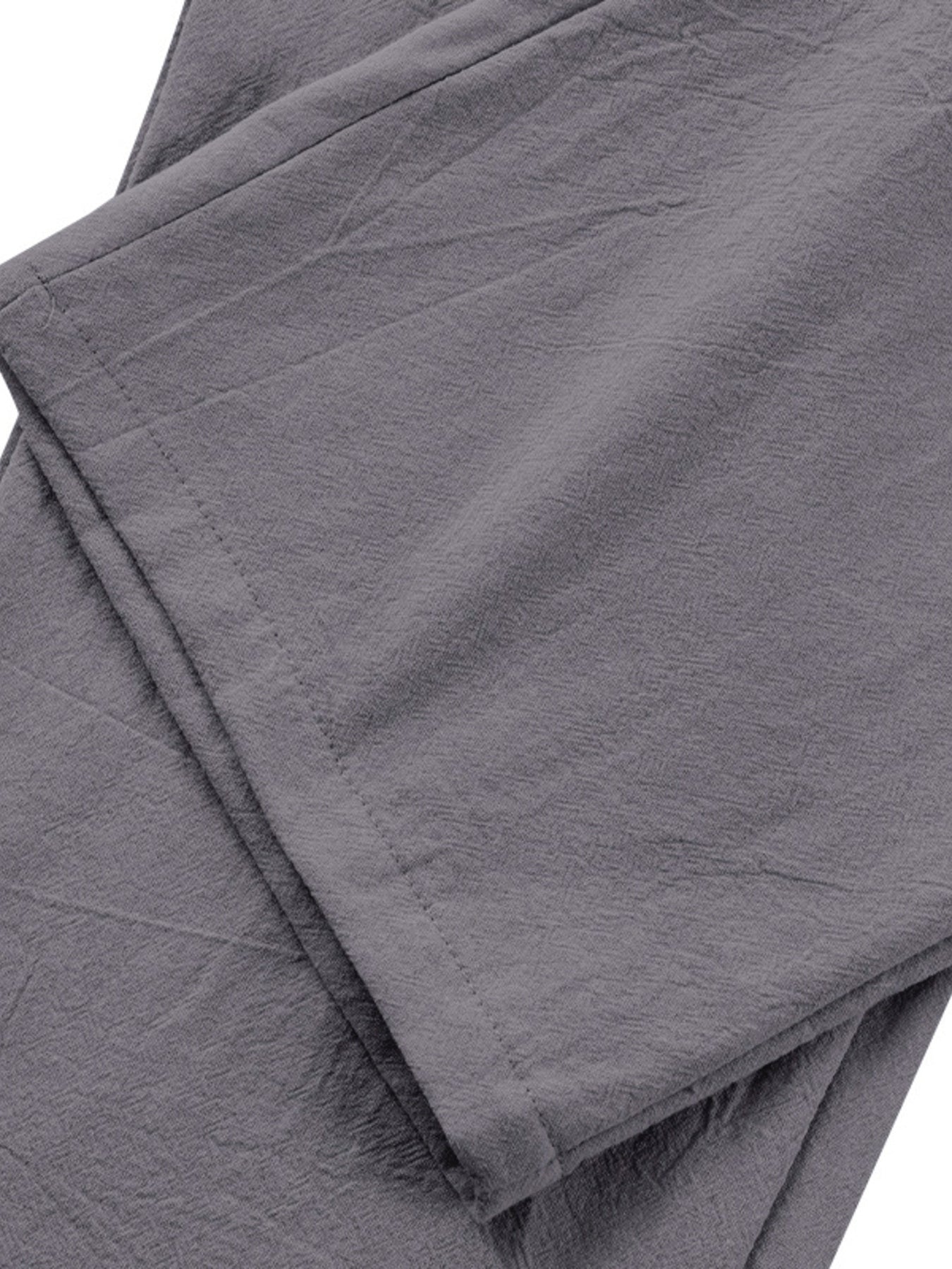 Grey relaxed fit sweatpants with pleated detail and textured fabric.